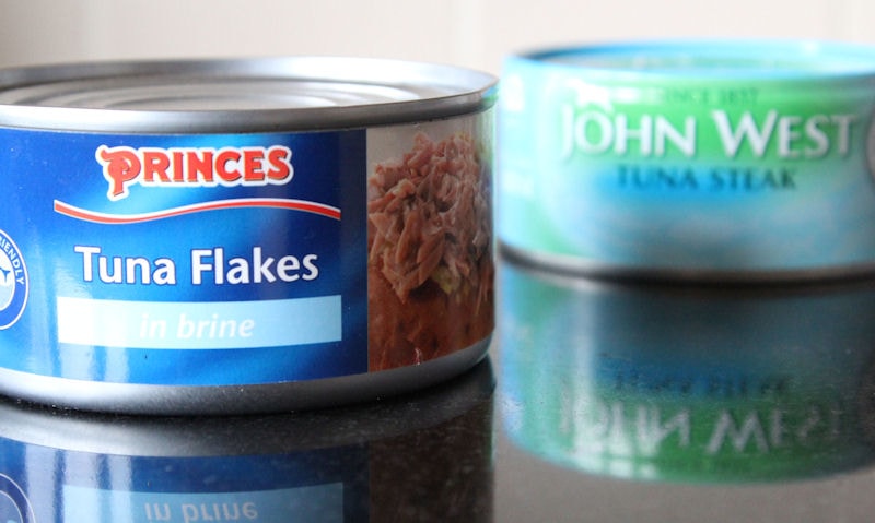 Tuna cans sitting on kitchen countertop