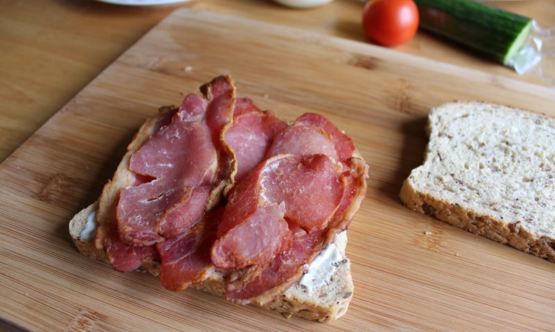 Slices of bacon layered on mayonnaise sliced bread