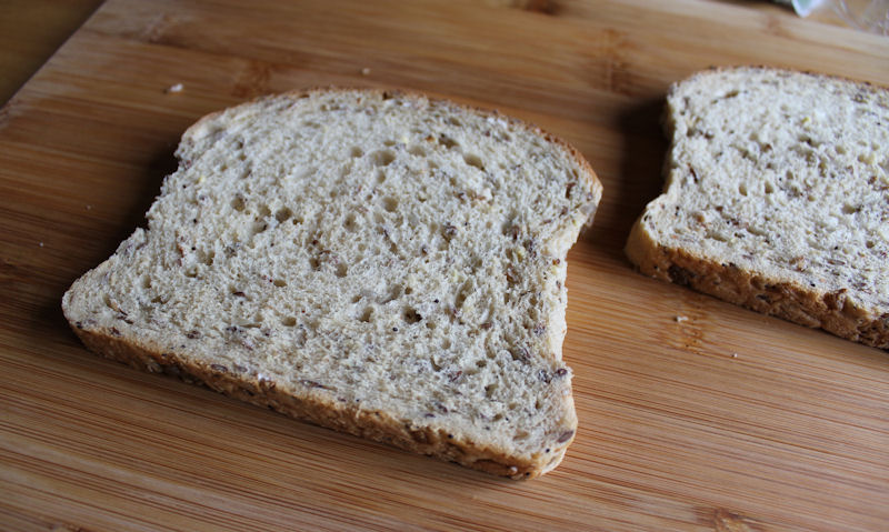 Two slices of wholemeal bread on chopping board