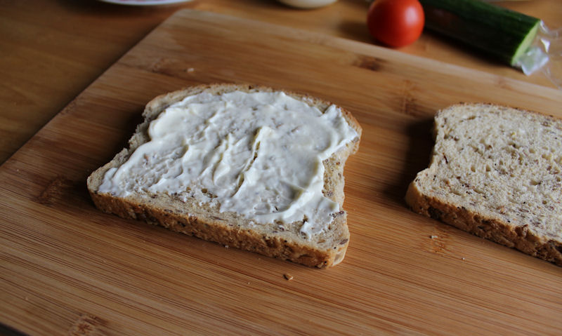 Mayonnaise spread on bottom wholemeal bread slice