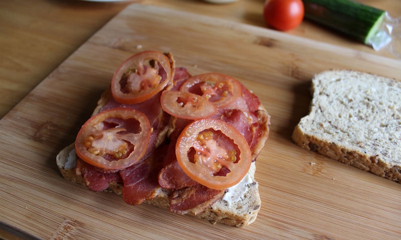 Tomatoes piled on top of bacon