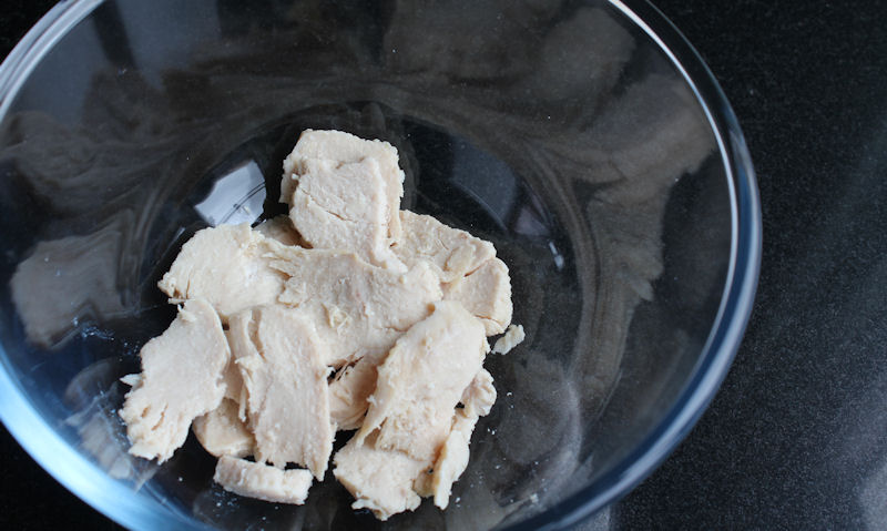 Roast chicken pieces in glass bowl