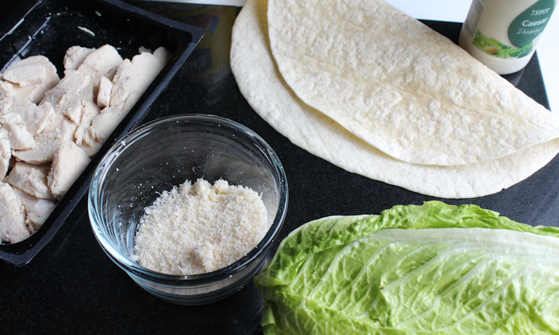 Chicken caesar wrap ingredients on chopping board