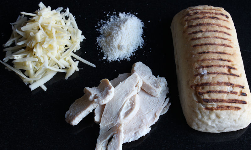 Chicken cheese panini ingredients on chopping board