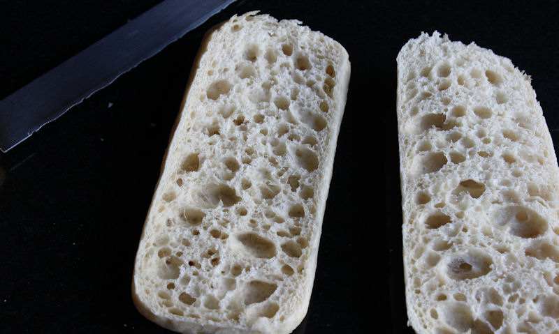 Cut open plain panini with knife