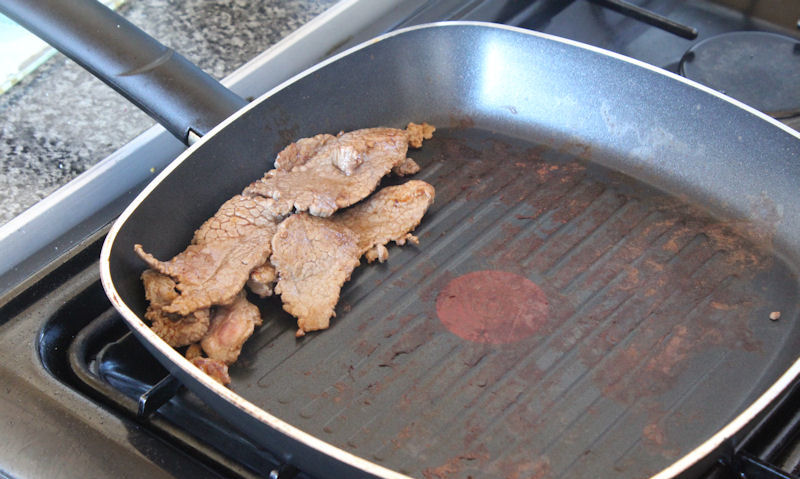 Pile of beef strips in pan