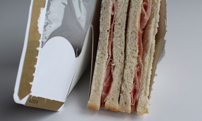 Open packet with ham visible in bread slices