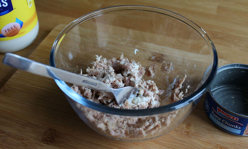 Mixing tuna mayonnaise in Pyrex bowl wityh fork