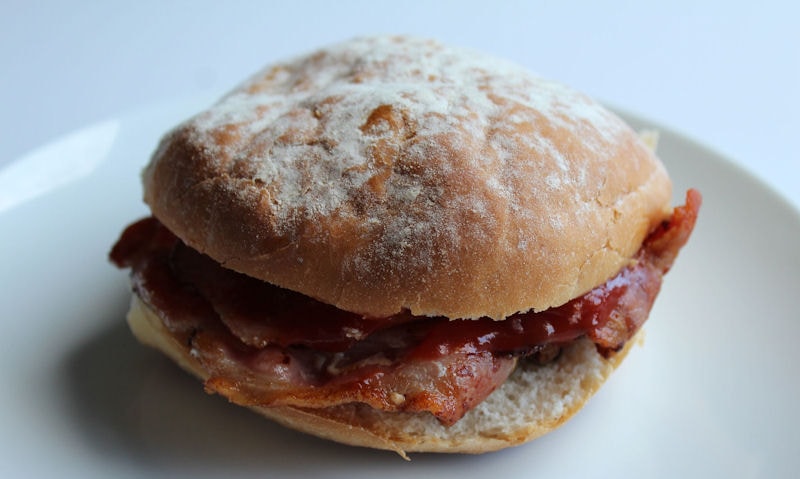 Floury bacon bap served on plate